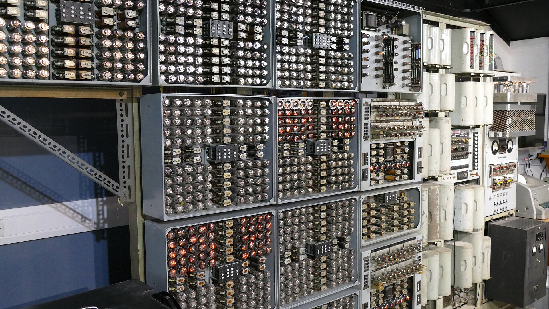 Figure 8 — 8 — The Harwell WITCH (Harwell Dekatron Computer) at The National Museum of Computing; its memory is racks of dekatrons, each storing a digit as a glow position. Photo: BadgersCP, CC0, via…
